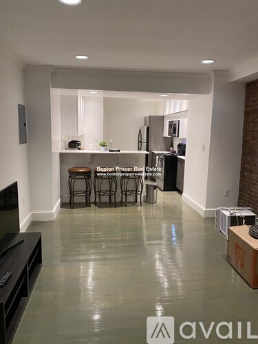 A living room with a television and a bar area.