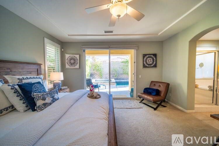 A bedroom with two beds and a ceiling fan.