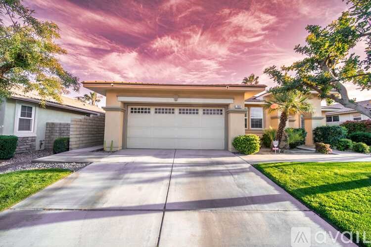A house with a driveway and garage in front of it.