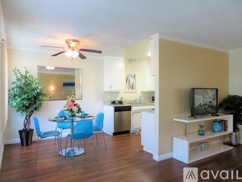 A living room with a dining table and chairs.