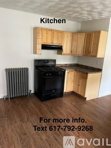A kitchen with wooden cabinets and a black stove top oven.