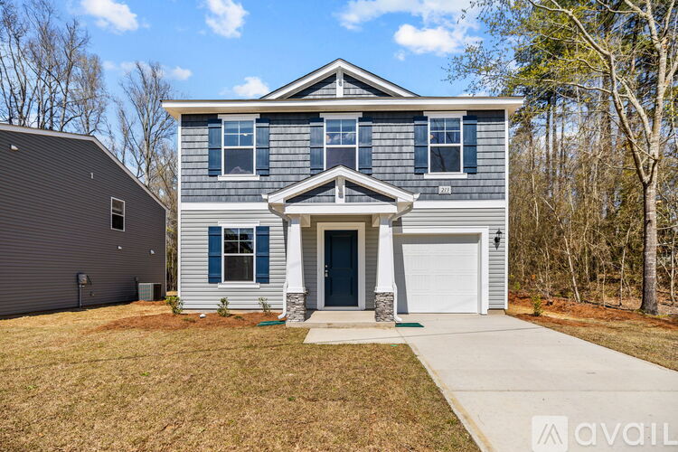 A two-story house with a garage is available for sale.