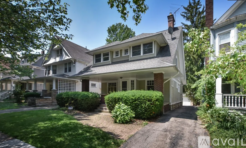 A house with a well-maintained lawn and a driveway leading to the front door.