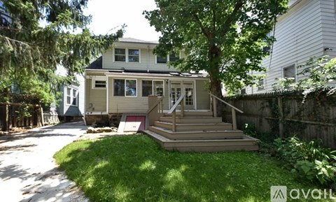 A house with a green lawn and trees around it.