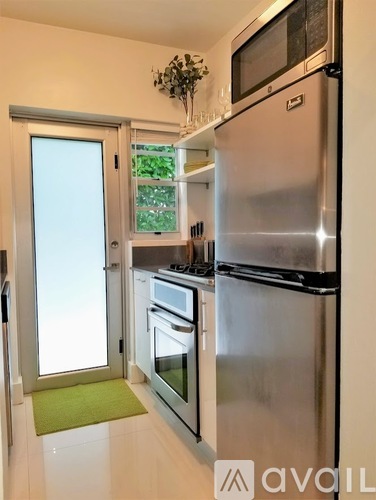 A kitchen with a stainless steel refrigerator and oven.