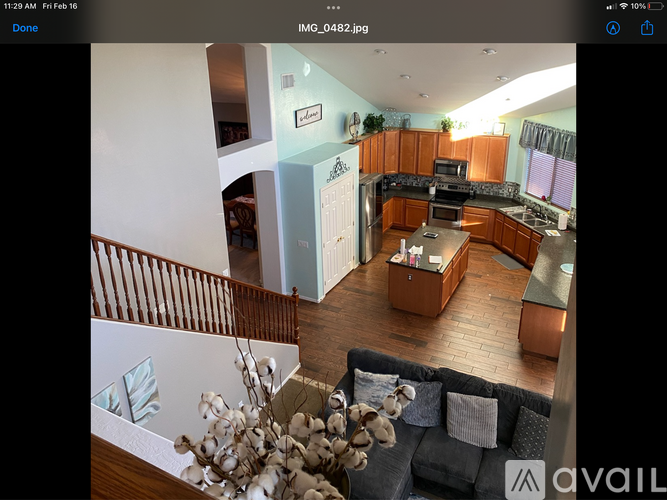 A modern kitchen with wooden floors and a large island.