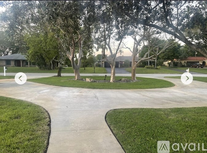 A residential area with a grassy lawn and trees.