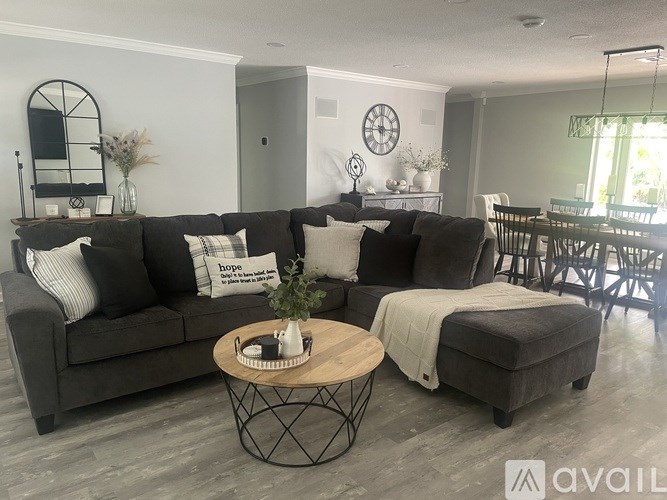 A living room with a grey sofa and a wooden coffee table.