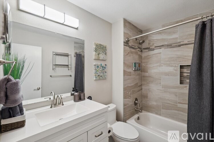 A bathroom with a white sink and a toilet.