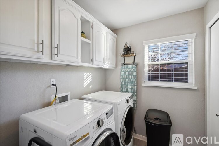 A white washing machine and dryer in a small laundry room.