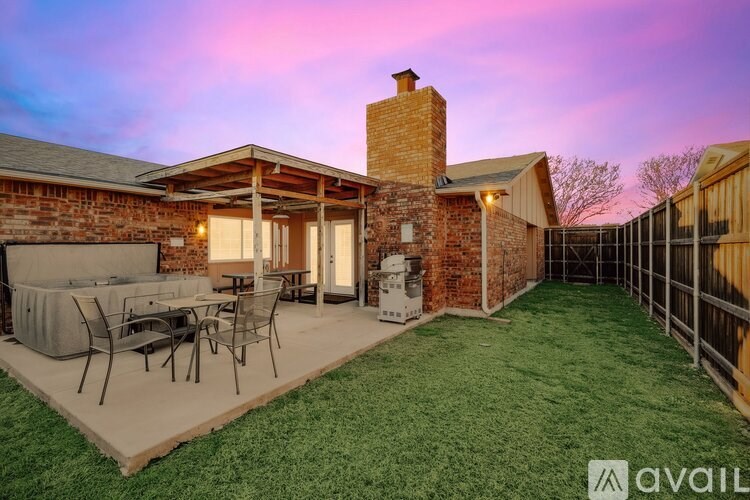 A house with a patio and a hot tub.