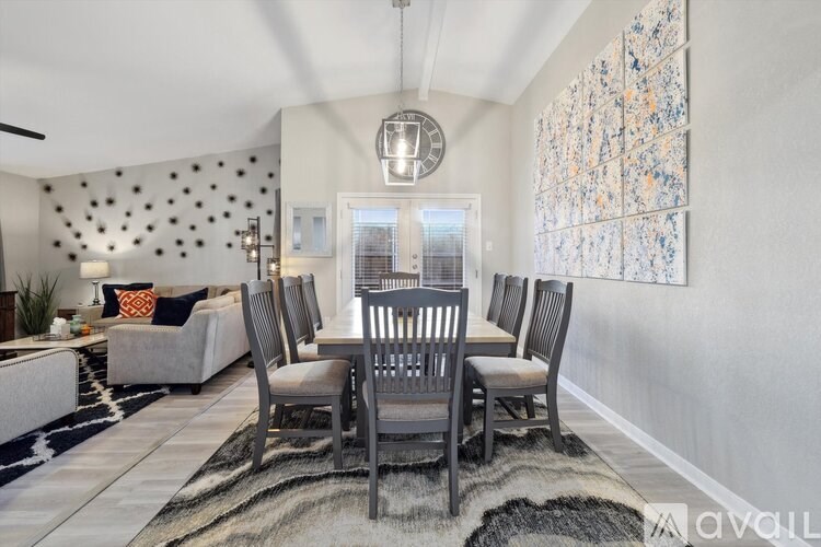 A dining room with a table set for four.