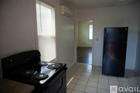 A white refrigerator in a kitchen with a fan on the ceiling.