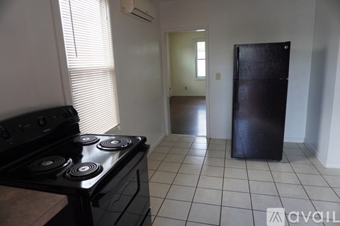 A kitchen with wooden cabinets and a white door.