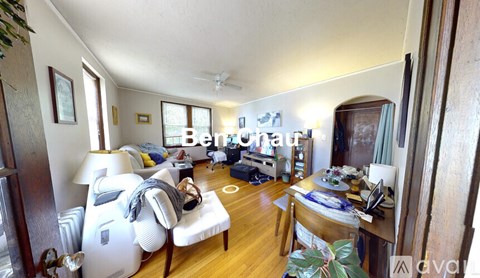 A living room with a white sofa and a wooden table.