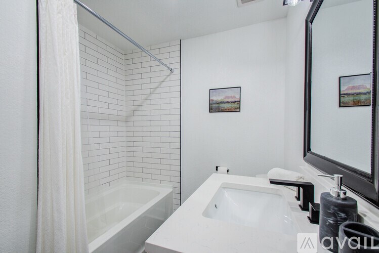 A white bathroom with a white tub and sink.