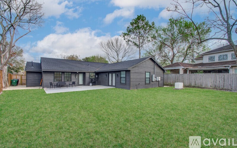 A house with a large lawn in front of it is for sale.