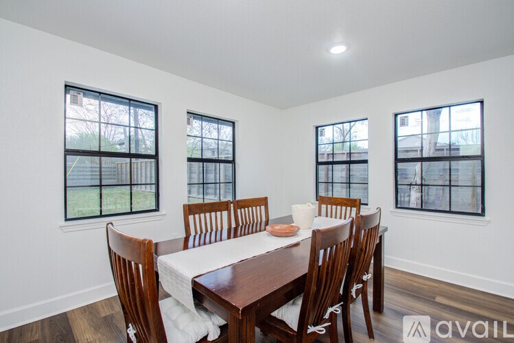 A dining room with a table set for six.