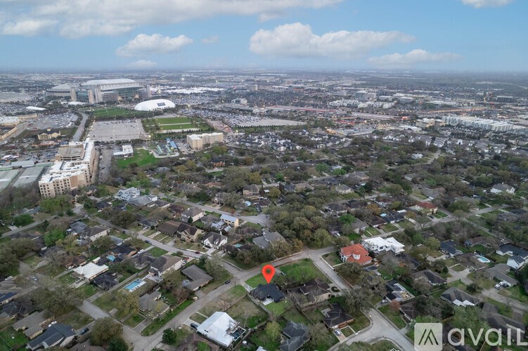 An aerial view of a city with a mix of residential and commercial buildings.