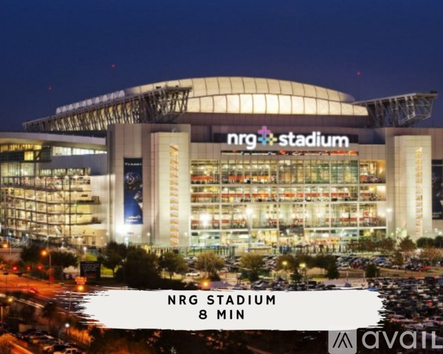 NRG Stadium is a large, illuminated stadium with a curved roof and multiple levels of seating.