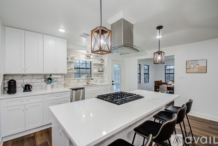 A modern kitchen with white cabinets and a large island.