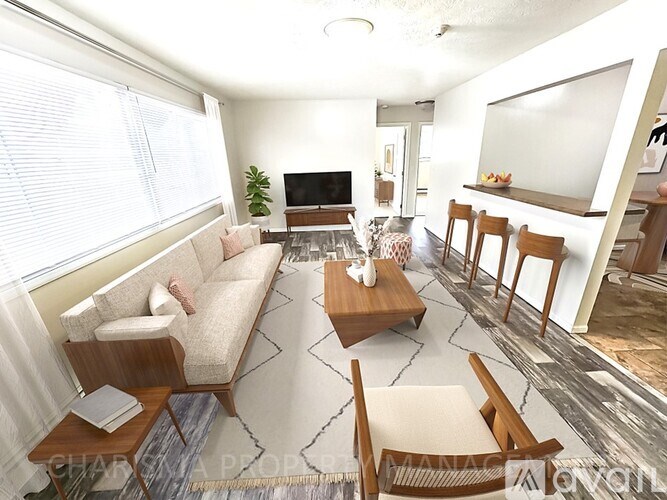 A living room with a couch, chairs, and a television.