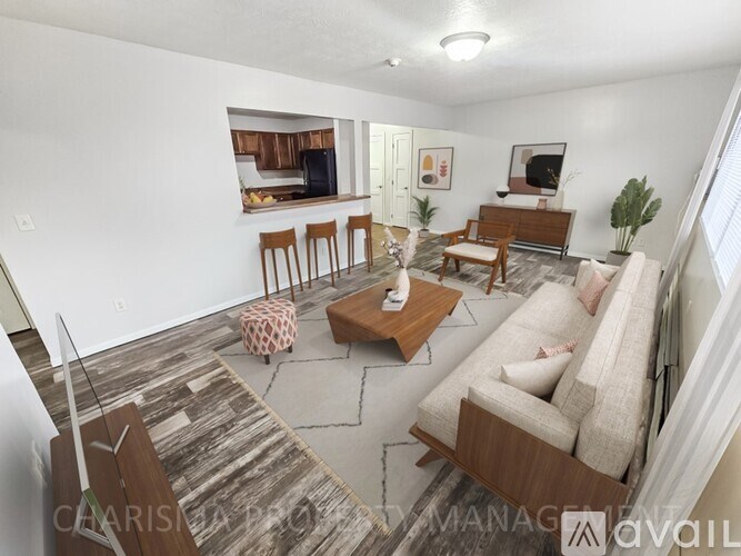 A living room with a couch, chair, and coffee table.