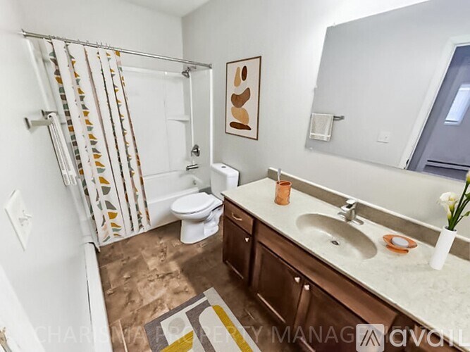 A bathroom with a toilet, sink, and shower.