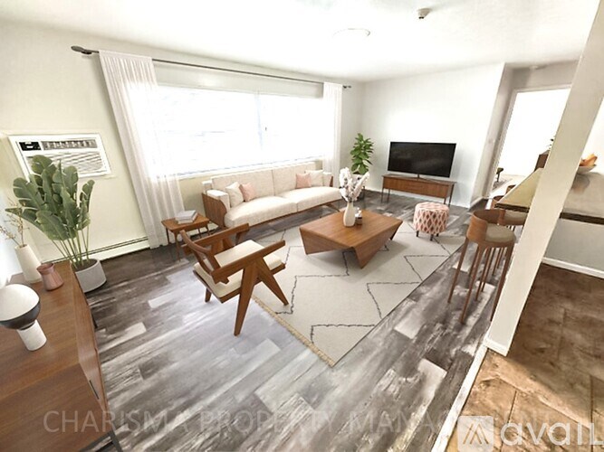 A living room with a couch, chairs, and a television.