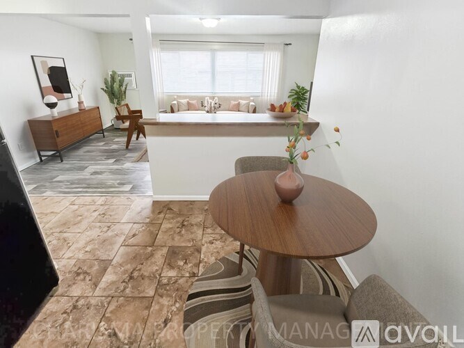 A living room with a brown table and striped couch.