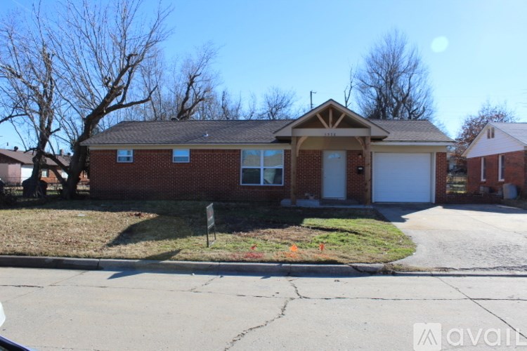 A house with a brown roof and a white garage door.