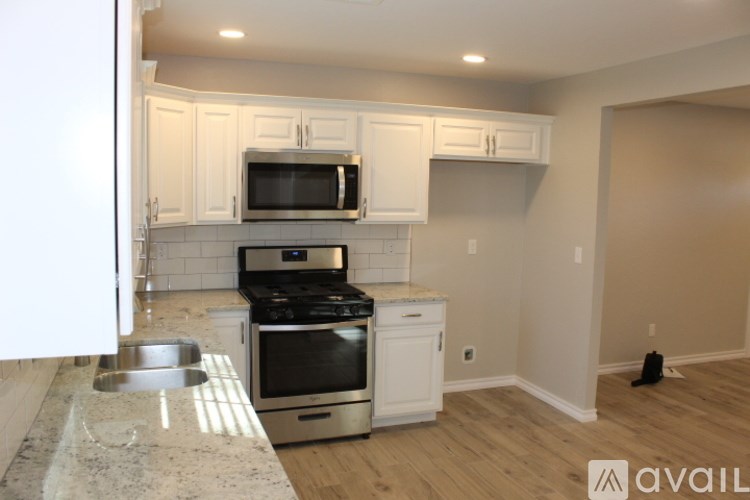 A kitchen with white cabinets and stainless steel appliances.