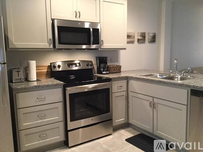 A kitchen with a stove top oven and microwave above it.