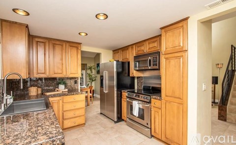 A kitchen with wooden cabinets and stainless steel appliances.