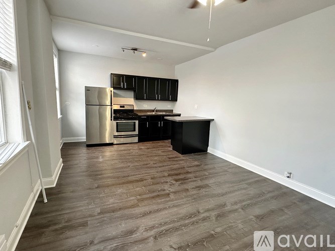 A kitchen with a refrigerator, oven, and cabinets.