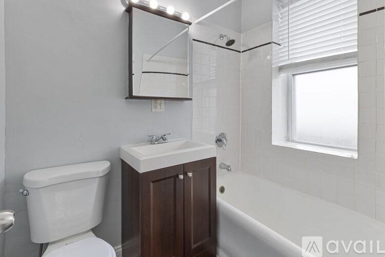 A white toilet sits next to a sink in a small bathroom.