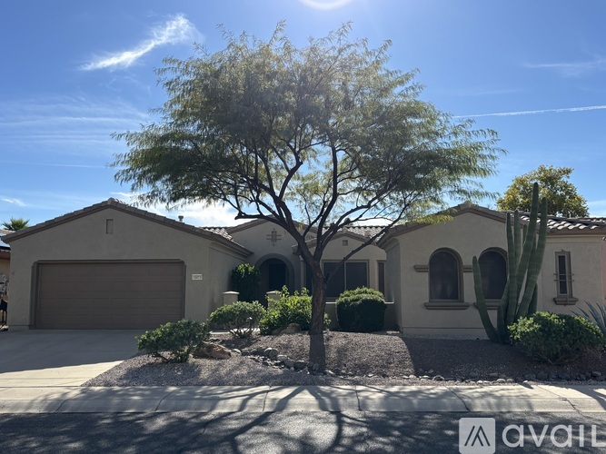 A house with a tree in front of it.