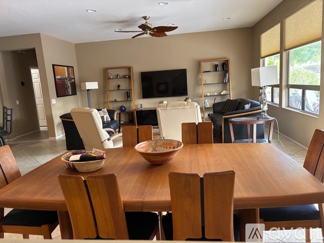 A dining room with a wooden table and chairs.