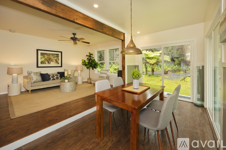 A dining room with a wooden table and chairs.