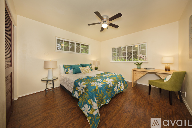 A bedroom with a bed, desk, and chair.