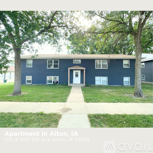 Apartment building with a blue exterior and a white door.
