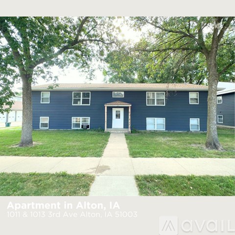 Apartment building with a blue exterior and a white door.