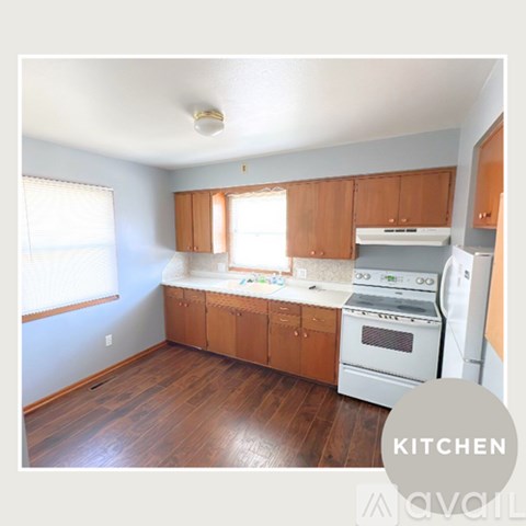 A kitchen with wooden cabinets and white appliances.