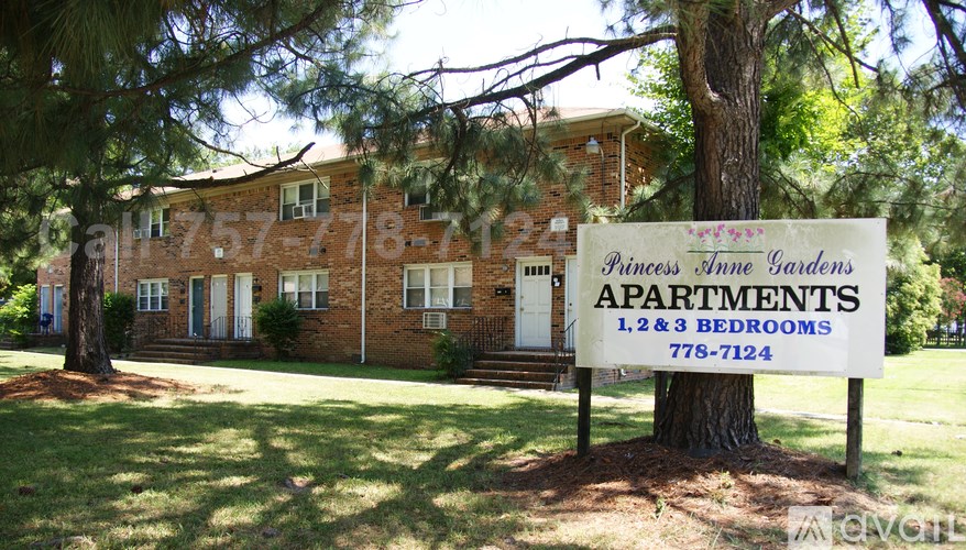 A sign for Princess Anne Gardens Apartments is in front of a brick building.