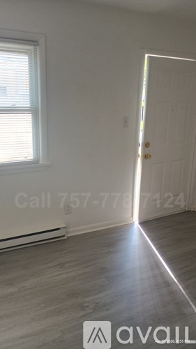 A room with two open doors and a white door on the right.