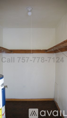 A room with a white ceiling and a phone number written on the wall.