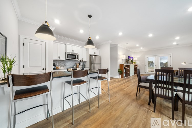 A modern kitchen with a bar area and dining table.