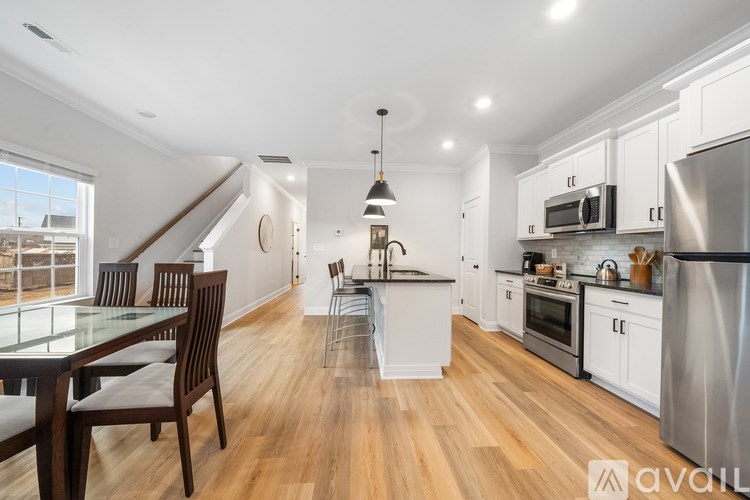 A kitchen with a table and chairs and a window.