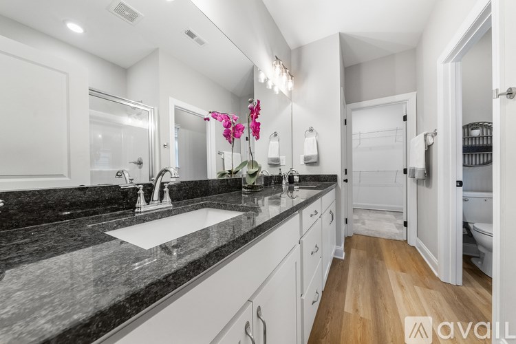 A bathroom with a marble countertop and a white sink.