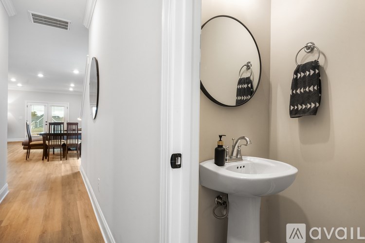 A bathroom with a white sink and a mirror.